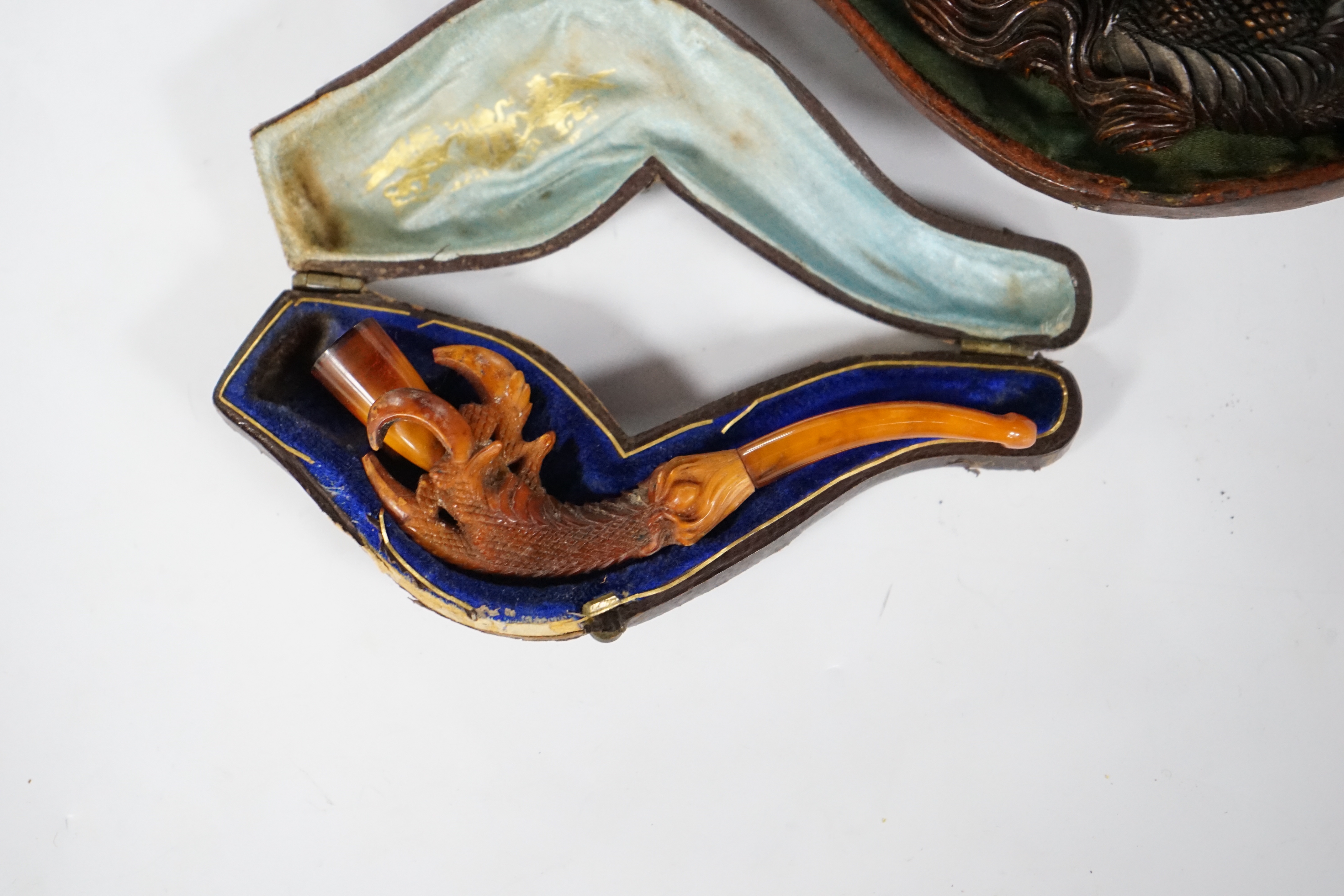 Two novelty Meerschaum pipes both with dragon claw talon pipe bowls and amber mouthpieces, largest 17cm long